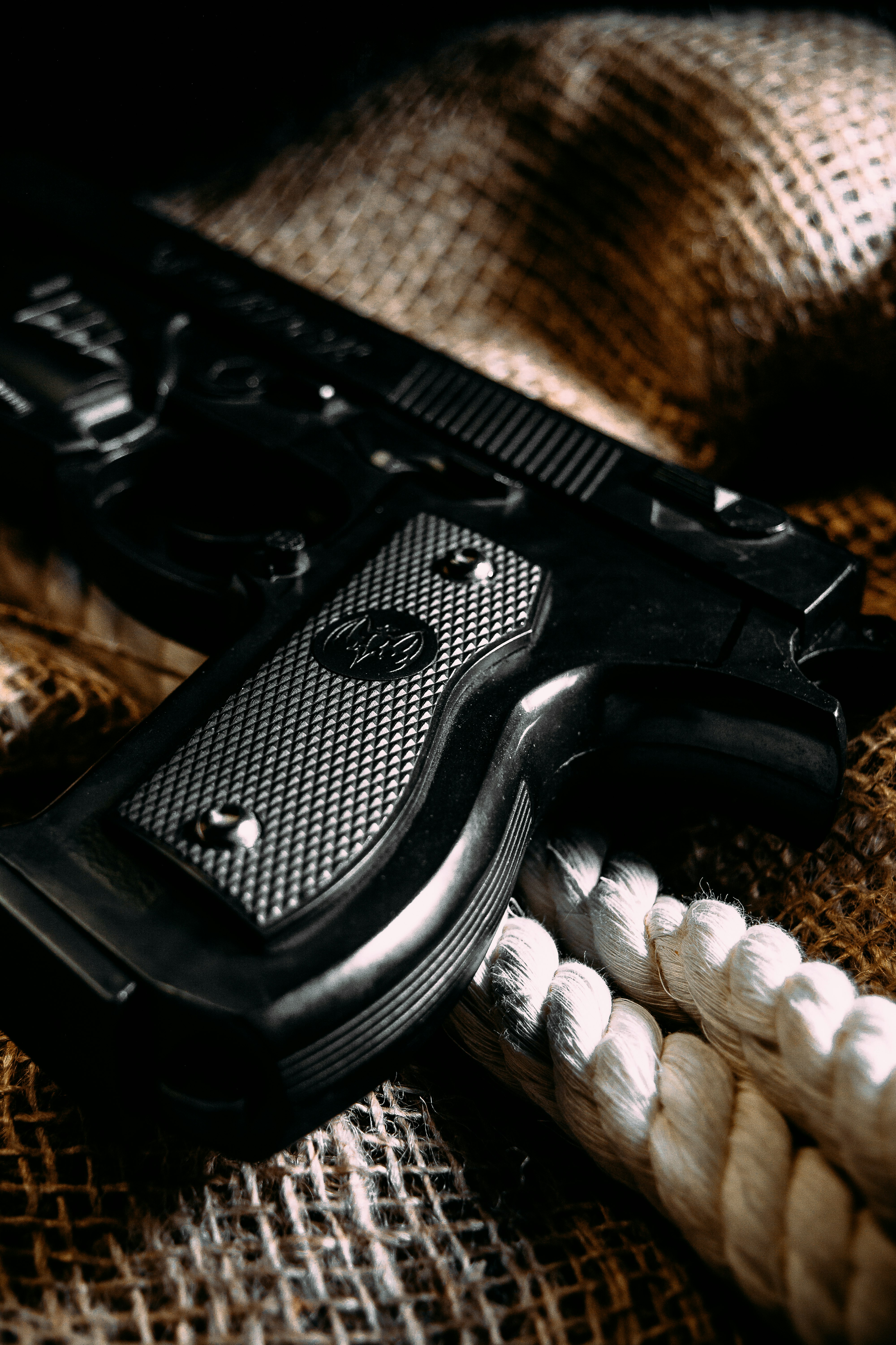 black semi automatic pistol on brown textile